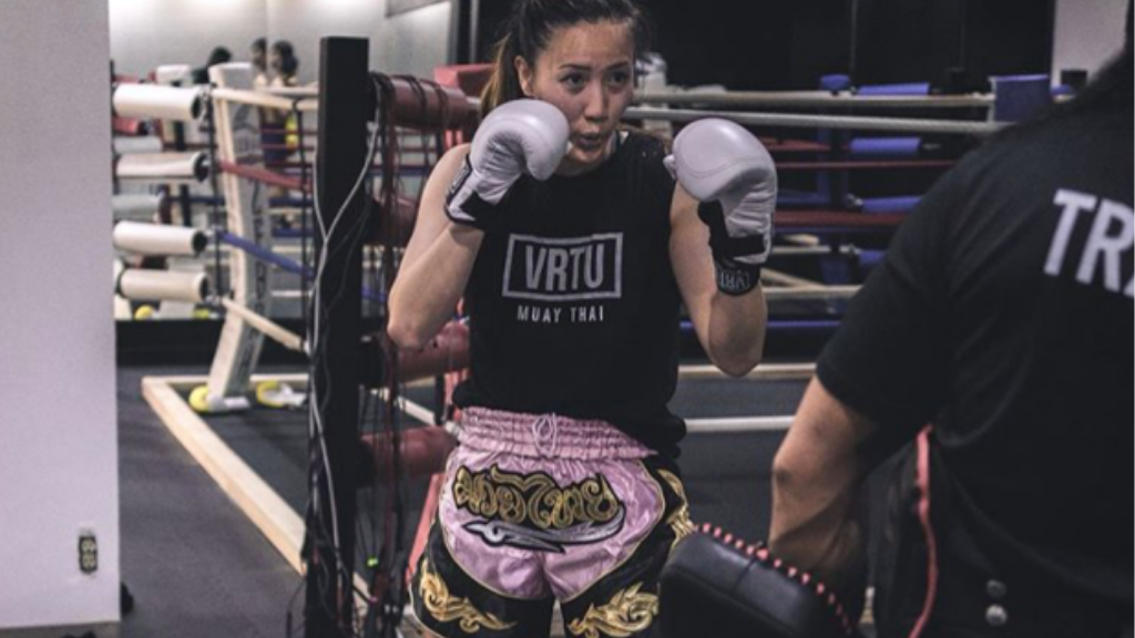 A girl practising boxing in VRTU gym